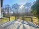 View from deck overlooking a spacious backyard with mature trees and lush greenery at 225 Woodfield Ct, Mcdonough, GA 30253