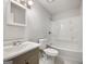 This bathroom has a shower-tub combo, toilet, and sink with storage at 225 Woodfield Ct, Mcdonough, GA 30253