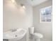 This bright bathroom has vanity, toilet, and a window at 225 Woodfield Ct, Mcdonough, GA 30253