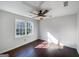 This bedroom features hardwood floors, a ceiling fan, and a window for natural light at 225 Woodfield Ct, Mcdonough, GA 30253