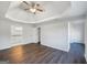 Spacious bedroom featuring tray ceilings, modern ceiling fan, and hardwood floors at 225 Woodfield Ct, Mcdonough, GA 30253