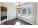 This eat-in kitchen boasts a bay window with storage and contemporary chandelier at 225 Woodfield Ct, Mcdonough, GA 30253