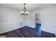 This dining room includes modern lighting and wainscoting at 225 Woodfield Ct, Mcdonough, GA 30253