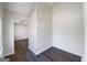 View down hallway showing open bedroom with dark hardwood floors at 225 Woodfield Ct, Mcdonough, GA 30253