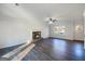 This living room has a fireplace, window, ceiling fan and hardwood flooring at 225 Woodfield Ct, Mcdonough, GA 30253
