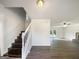Bright living room with staircase, hardwood floors, fireplace, and view to the backyard at 225 Woodfield Ct, Mcdonough, GA 30253