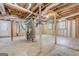 Unfinished basement featuring essential utilities, studs, and potential for future finishing, bathed in natural light at 3159 Nursery Se Rd, Smyrna, GA 30082