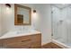 Modern bathroom featuring a vanity with marble countertop, a sleek mirror, and a tiled glass walk-in shower at 3159 Nursery Se Rd, Smyrna, GA 30082