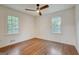 Bright, empty bedroom with hardwood floors and natural light coming through two windows at 3159 Nursery Se Rd, Smyrna, GA 30082