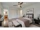 Comfortable staged bedroom featuring hardwood floors, a ceiling fan and ensuite bathroom at 3159 Nursery Se Rd, Smyrna, GA 30082