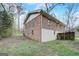 Side view of a brick home showing a fenced yard, greenery, and a well-maintained lawn at 3159 Nursery Se Rd, Smyrna, GA 30082