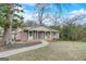 Charming brick home with a welcoming front porch, complemented by a well-manicured lawn and mature trees at 3159 Nursery Se Rd, Smyrna, GA 30082