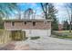 Rear exterior view of a brick home with a two-car garage and a fenced yard at 3159 Nursery Se Rd, Smyrna, GA 30082