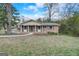 Charming brick home featuring a well-manicured lawn and a welcoming front entrance with a walkway at 3159 Nursery Se Rd, Smyrna, GA 30082