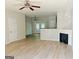 Spacious living room with vinyl flooring, ceiling fan, and fireplace at 4415 Stone Gate Way, Atlanta, GA 30344