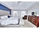 Main bedroom with king-size bed, armchair, and dresser at 1285 Great Oaks Dr, Lawrenceville, GA 30045