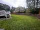 Spacious backyard with retaining wall and lawn at 883 Pine Shoals Dr, Atlanta, GA 30349