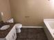 Bathroom featuring a bathtub, toilet, and granite vanity at 883 Pine Shoals Dr, Atlanta, GA 30349
