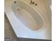 Close up of bathtub featuring built-in jacuzzi jets and tile surround at 3705 Sandhill Se Dr, Conyers, GA 30094
