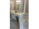 Bathroom features a vanity with white cabinets and countertop, and a soaking tub with tile surround at 3705 Sandhill Se Dr, Conyers, GA 30094