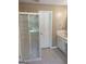 Bathroom featuring a glass shower and vanity with countertop and storage at 3705 Sandhill Se Dr, Conyers, GA 30094