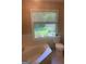 Bathroom featuring bathtub, toilet, and a window with a view of the backyard at 3705 Sandhill Se Dr, Conyers, GA 30094