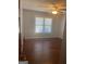 Bedroom featuring hardwood floors, ceiling fan, and large window at 3705 Sandhill Se Dr, Conyers, GA 30094