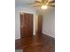 Bedroom with hardwood floors, ceiling fan, and closet with folding doors at 3705 Sandhill Se Dr, Conyers, GA 30094
