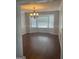 Bright dining room featuring a large window, chandelier, and hardwood floors at 3705 Sandhill Se Dr, Conyers, GA 30094