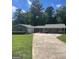 Charming single-story home featuring a long driveway and lush green lawn at 3705 Sandhill Se Dr, Conyers, GA 30094