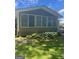 Sunroom on the back of the home with windows overlooking the yard at 3705 Sandhill Se Dr, Conyers, GA 30094