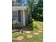 Landscaped yard with a stone walking path on the side of the home at 3705 Sandhill Se Dr, Conyers, GA 30094