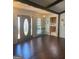 Inviting foyer with hardwood floors, view to the kitchen, and decorative lighting at 3705 Sandhill Se Dr, Conyers, GA 30094