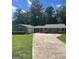 Ranch-style home with an attached two-car garage and long driveway at 3705 Sandhill Se Dr, Conyers, GA 30094
