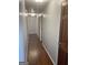 Hallway with hardwood floors, neutral walls, and paneled doors at 3705 Sandhill Se Dr, Conyers, GA 30094
