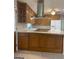 A large kitchen with ample wood cabinets, countertop space, and tile flooring at 3705 Sandhill Se Dr, Conyers, GA 30094
