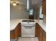 Kitchen showcasing an electric stovetop, wood cabinetry, and neutral countertops at 3705 Sandhill Se Dr, Conyers, GA 30094
