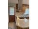 Kitchen with tile floors, wood cabinets, and a cooktop at 3705 Sandhill Se Dr, Conyers, GA 30094