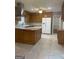 Well-lit kitchen with wood cabinets, an island, and a modern stainless steel vent hood at 3705 Sandhill Se Dr, Conyers, GA 30094