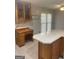 Open kitchen featuring an island with wood cabinets, a built-in desk, and ample countertop space at 3705 Sandhill Se Dr, Conyers, GA 30094
