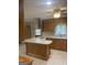 Kitchen with tile floors, a center island, and wood cabinets at 3705 Sandhill Se Dr, Conyers, GA 30094
