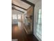 Bright living room with hardwood floors, exposed beams, and a brick fireplace at 3705 Sandhill Se Dr, Conyers, GA 30094