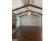Living room featuring hardwood floors, brick fireplace, and exposed ceiling beams at 3705 Sandhill Se Dr, Conyers, GA 30094