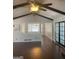 View of living room with dark wood floors, ceiling fan, and black-framed french doors at 3705 Sandhill Se Dr, Conyers, GA 30094