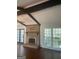Spacious living room with a brick fireplace, large windows and hardwood floors at 3705 Sandhill Se Dr, Conyers, GA 30094