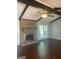 Spacious living room featuring a brick fireplace, beamed ceiling and hardwood floors at 3705 Sandhill Se Dr, Conyers, GA 30094