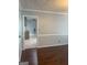 View of living room with dark wood floors showing the doorway to the kitchen at 3705 Sandhill Se Dr, Conyers, GA 30094