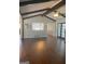 Living room with hardwood floors, exposed beams, and black framed french doors at 3705 Sandhill Se Dr, Conyers, GA 30094