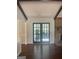 View of living room with dark wood floors and french doors leading to the outside at 3705 Sandhill Se Dr, Conyers, GA 30094