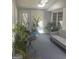 Well-lit sunroom featuring multiple windows, indoor plants, and comfortable seating for relaxation at 3705 Sandhill Se Dr, Conyers, GA 30094